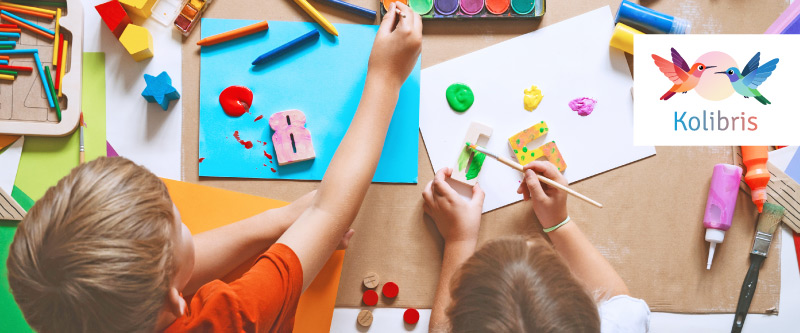 Bild f&uuml;r Projekt Kolibris: kleine Kinder basteln an einem Tisch